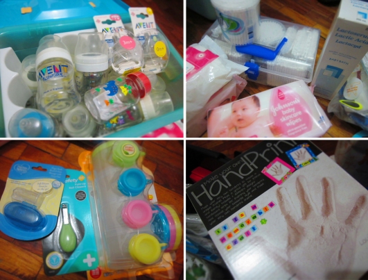 baby bottles and cotton buds and baby nail clippers and handprint mold